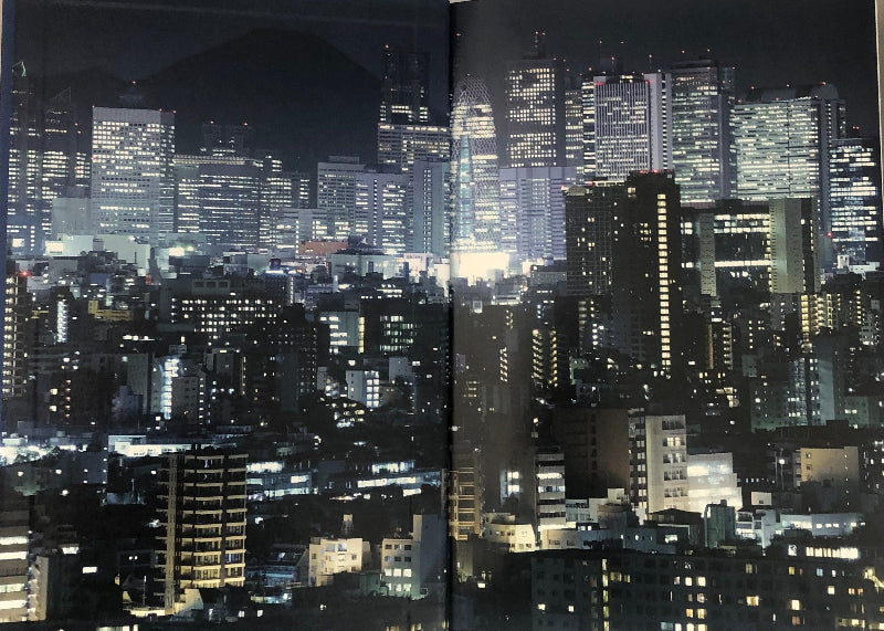 Cityscape of Tokyo at night with illuminated skyscrapers and buildings.