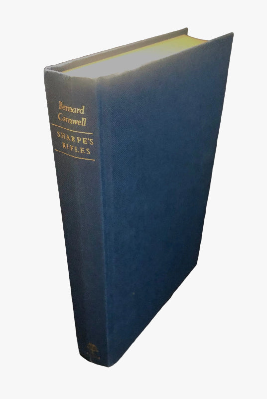 Pictured without its dustjacket, A Signed First UK Printing of Sharpe's Rifles by Bernard Cornwell