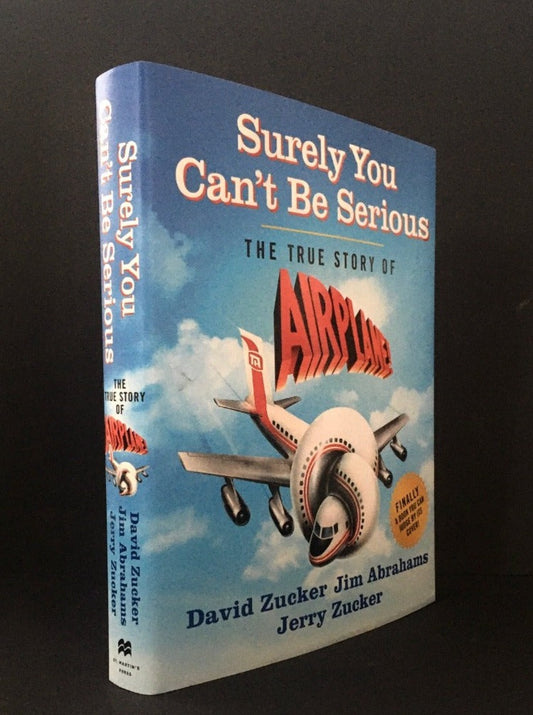 SURELY YOU CAN'T BE SERIOUS. The True Story of Airplane! Signed by David Zucker, Jim Abrahams & Jerry Zucker,